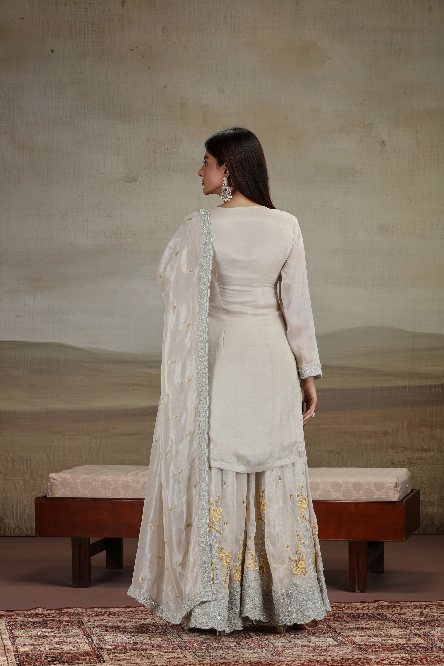 Woman in a traditional outfit with a plain background