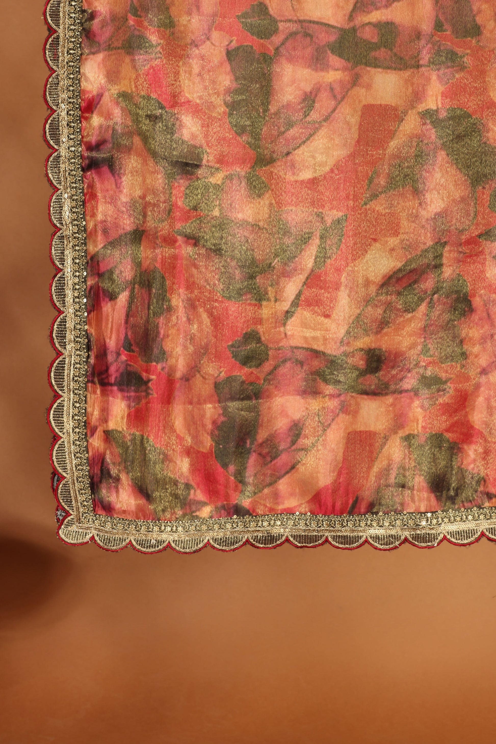 Dress with leaf pattern and decorative border on a brown background