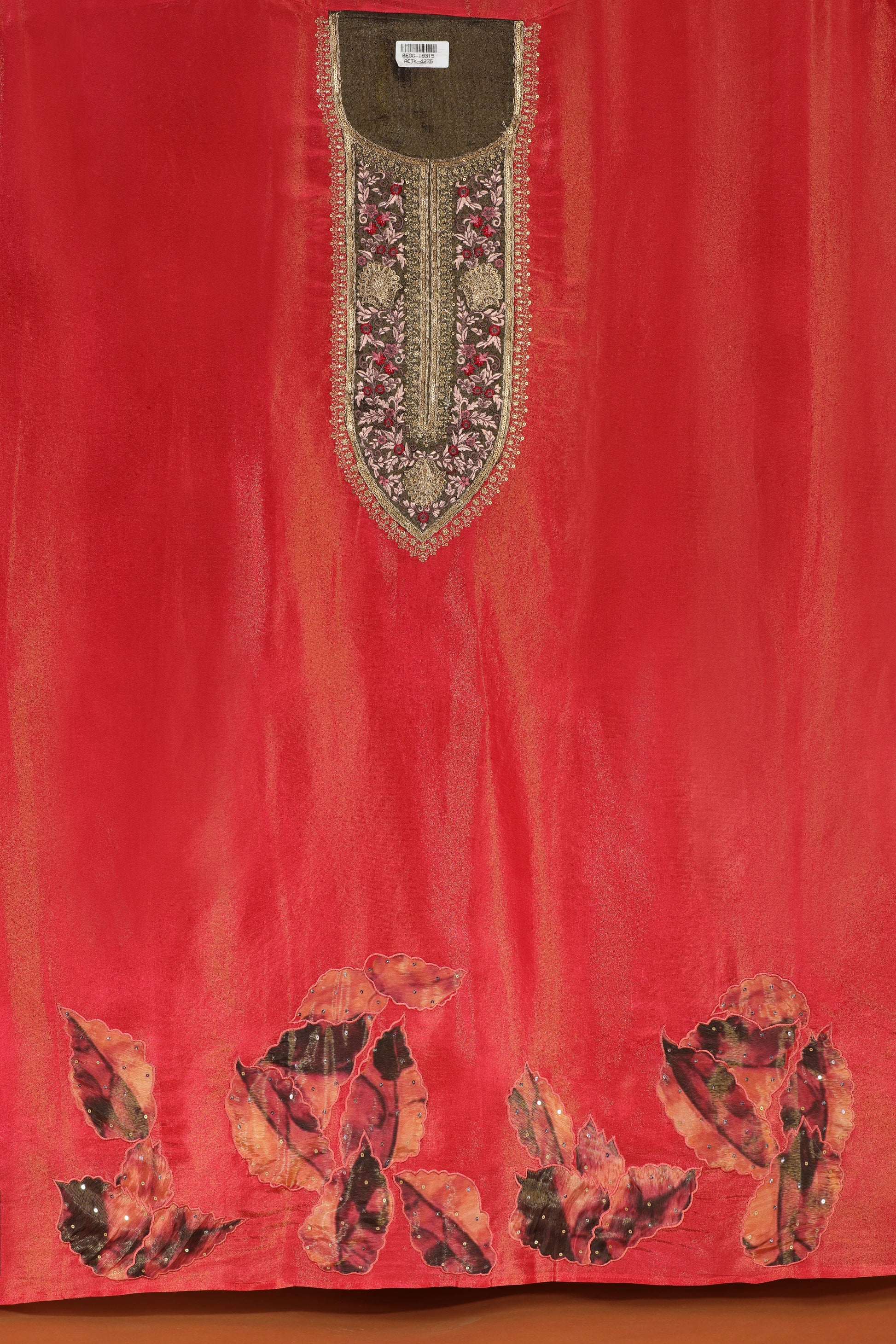 Red dress material fabric with floral embroidery on a plain background