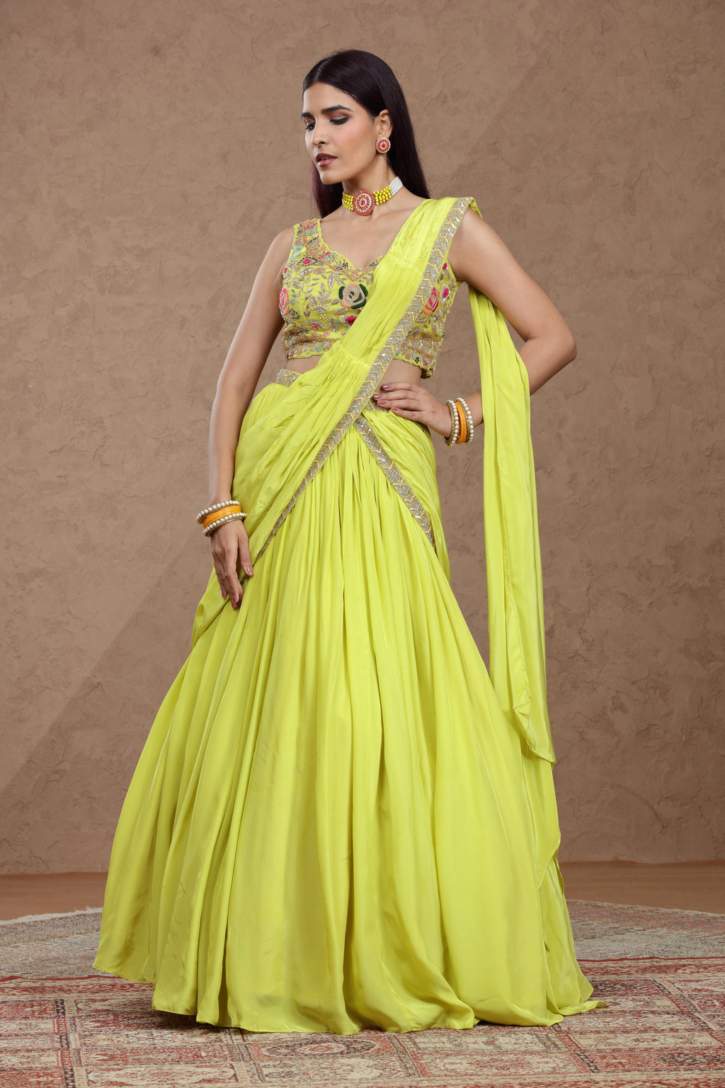 A woman in a vibrant lime green traditional Indian lehenga poses gracefully