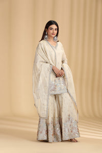 Woman wearing a traditional outfit with a beige background