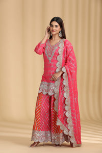 Woman wearing a pink traditional outfit with intricate patterns on a beige background