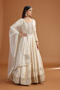 Woman wearing a traditional beige embroidered Ivory Banarasi Silk Gown