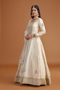 Woman wearing a traditional Ivory Banarasi Gown with Mirror, Moti & Zari Work
