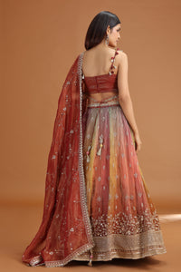 Woman wearing Roopkala traditional maroon tissue lehenga 