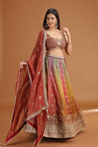 Woman wearing a traditional multicolored lehenga with mirror work