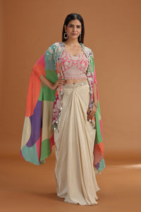 Woman wearing a Pink Crepe Suit with a colorful dupatta on an orange background