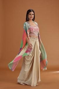 Woman wearing a Pink Crepe Salwar with a colorful dupatta against a brown background