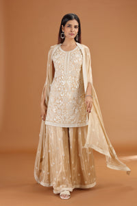 Woman wearing a Beige Crepe Suit Set with Sequins, Thread & Cutdana Work