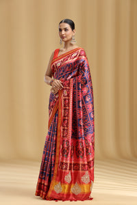 Woman wearing a Red Patola Silk Saree with Weaving & Stone Work