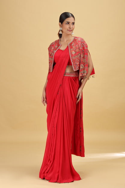 Woman wearing a red crepe saree with a dola silk blouse and jacket 