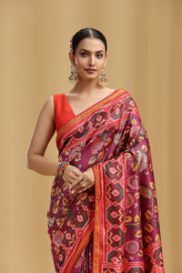 Woman wearing a vibrant Purple Patola Silk Saree