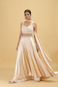 Woman wearing a beige chinon salwar suit on a beige background