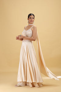 Woman wearing a beige evening gown suit on a beige background