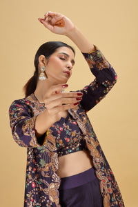 Woman wearing a floral patterned outfit against a beige background