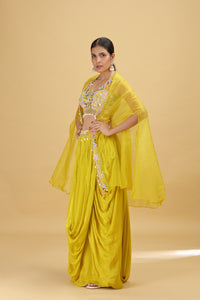 Woman in a lime yellow salwar kameez suit with a beige background