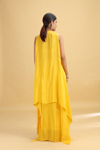 Woman wearing a yellow dress with a dupatta on a beige background