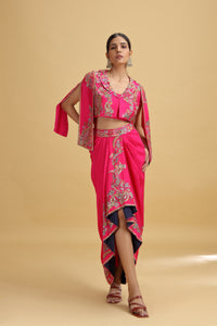Woman wearing a pink dola silk salwar kameez with embroidery on a beige background