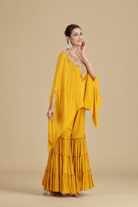 Woman wearing a yellow kurta set with a beige background
