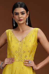 Woman wearing a green salwar dress with a brown background