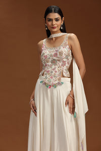 Woman wearing a beige crepe salwar suit against a brown background