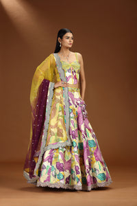 Woman wearing a colorful traditional lehenga and yellow dupatta