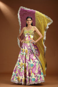 Woman wearing a colorful floral lehenga with a matching dupatta