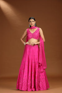 Woman wearing a bright pink lehenga set
