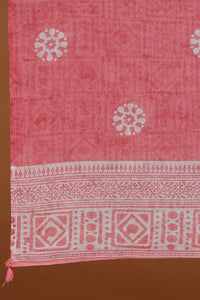 Pink fabric with white patterns on a brown background