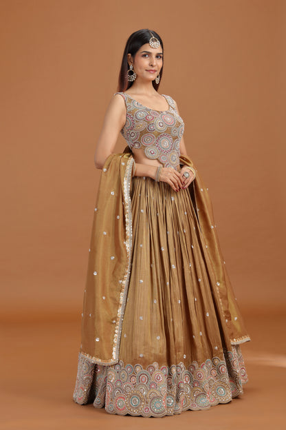 Woman wearing a dusty gold sequin work lehenga set from Roopkala