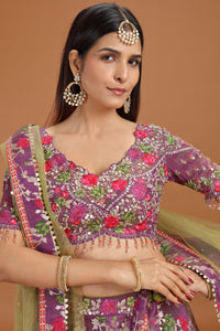 Woman wearing a traditional embroidered purple blouse with floral patterns on a brown background