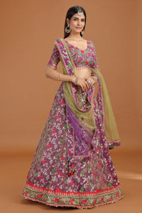Woman wearing a traditional embroidered Purple Banarasi Silk Lehenga Set with Net Dupatta on a brown background