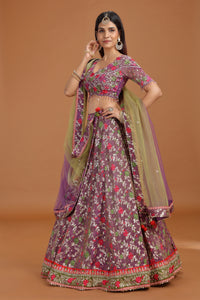 Woman wearing a traditional outfit with a floral pattern on a brown background