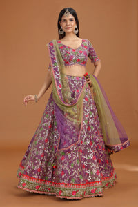 Woman wearing a traditional purple and green embroidered outfit on a brown background