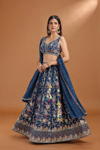 Woman wearing a blue embroidered traditional outfit on a brown background