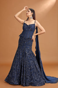Woman wearing a blue evening gown with a brown background