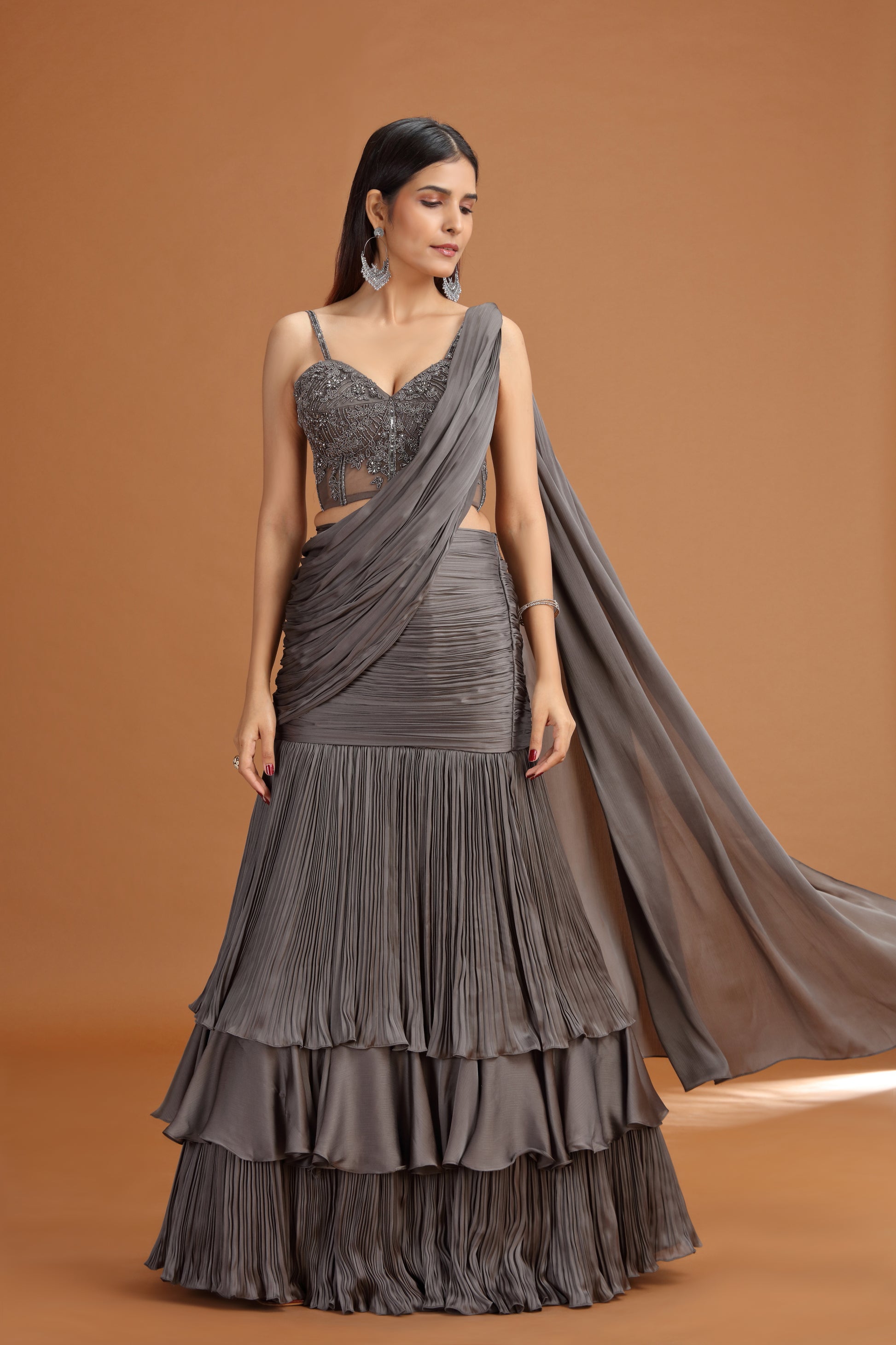 Woman wearing a grey lehenga skirt with a draped fabric 