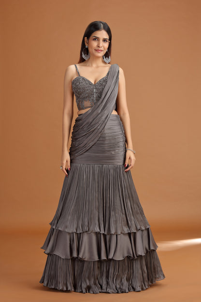 Woman wearing a grey lehenga crepe skirt with a brown background