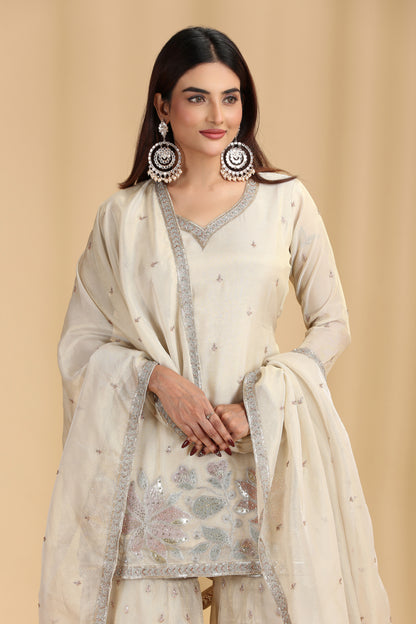 Woman wearing a traditional outfit with a beige background