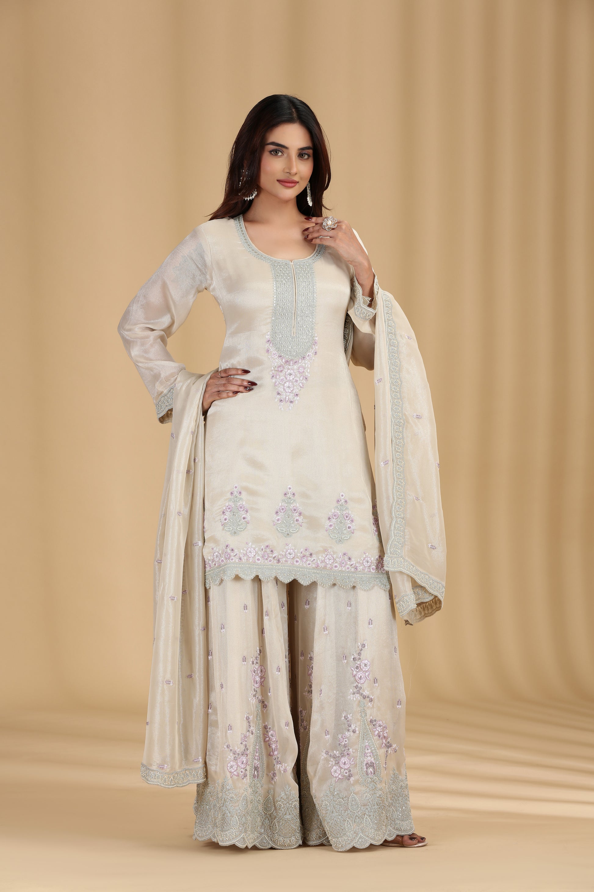 Woman wearing a traditional outfit with floral patterns on a beige background