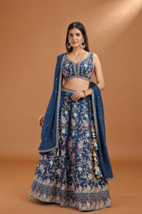 Woman wearing a blue floral traditional outfit on a brown background
