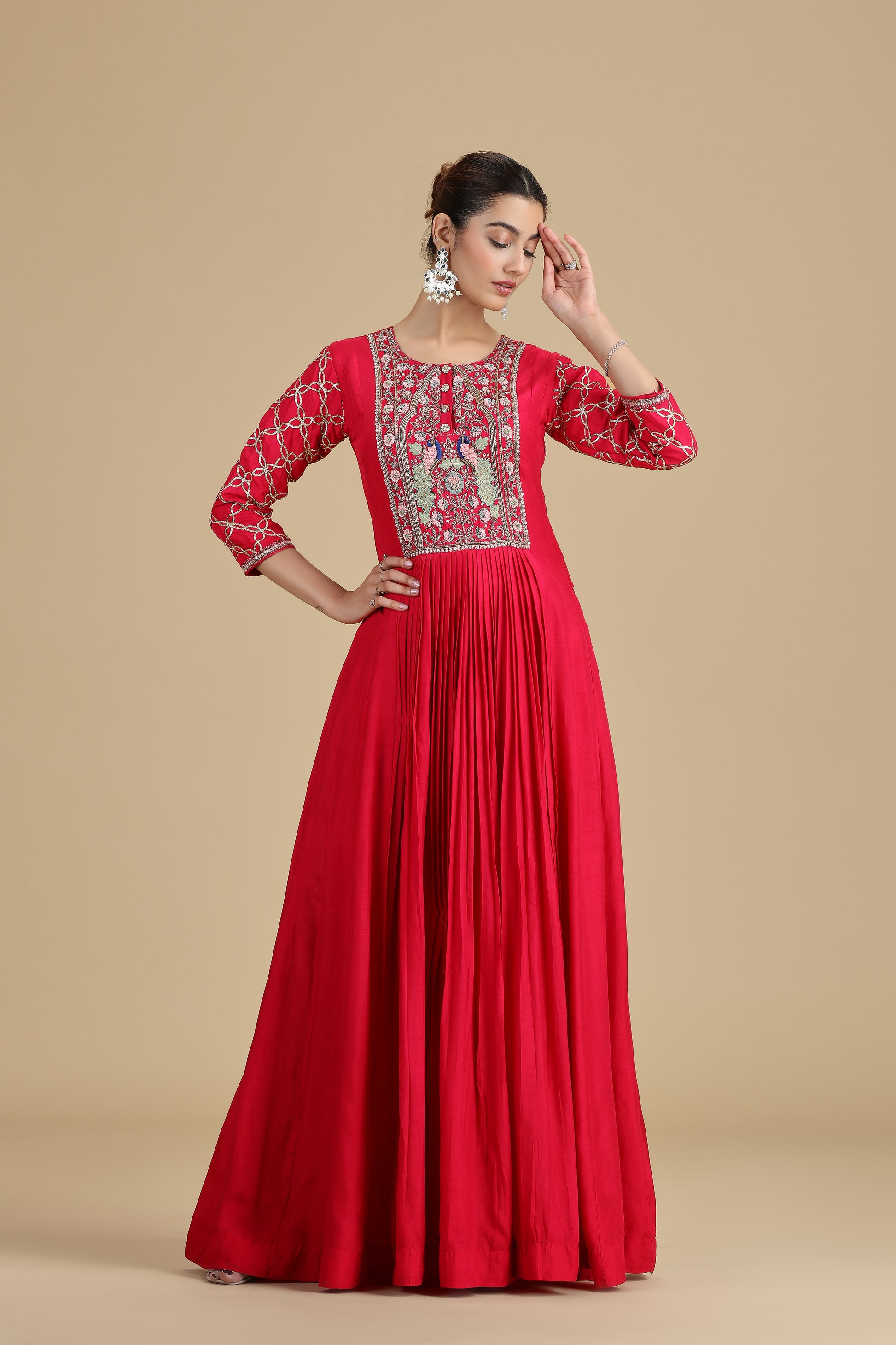 pink kurta set for women with intricate embroidery on a beige background