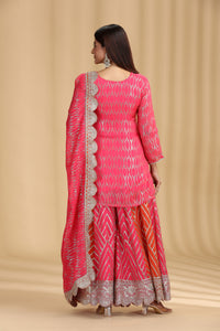 women showing back wearing a designer pink georgette salwar suit with intricate sequins work