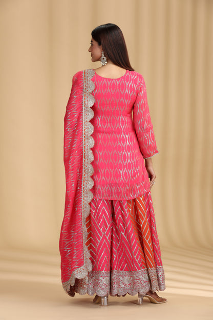women showing back wearing a designer pink georgette salwar suit with intricate sequins work