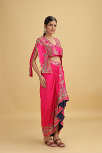 Woman wearing a pink dola silk suit with a beige background