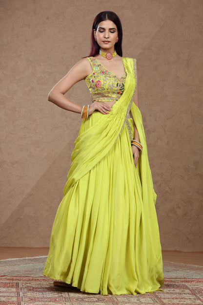Woman wearing a bright yellow saree with a matching blouse against a brown background