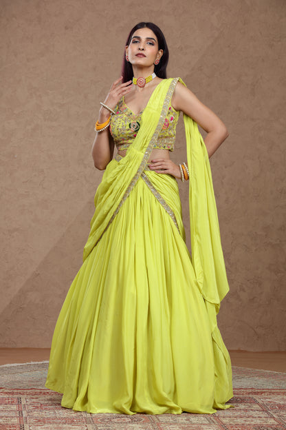 Woman wearing a bright yellow saree with a matching blouse against a brown background
