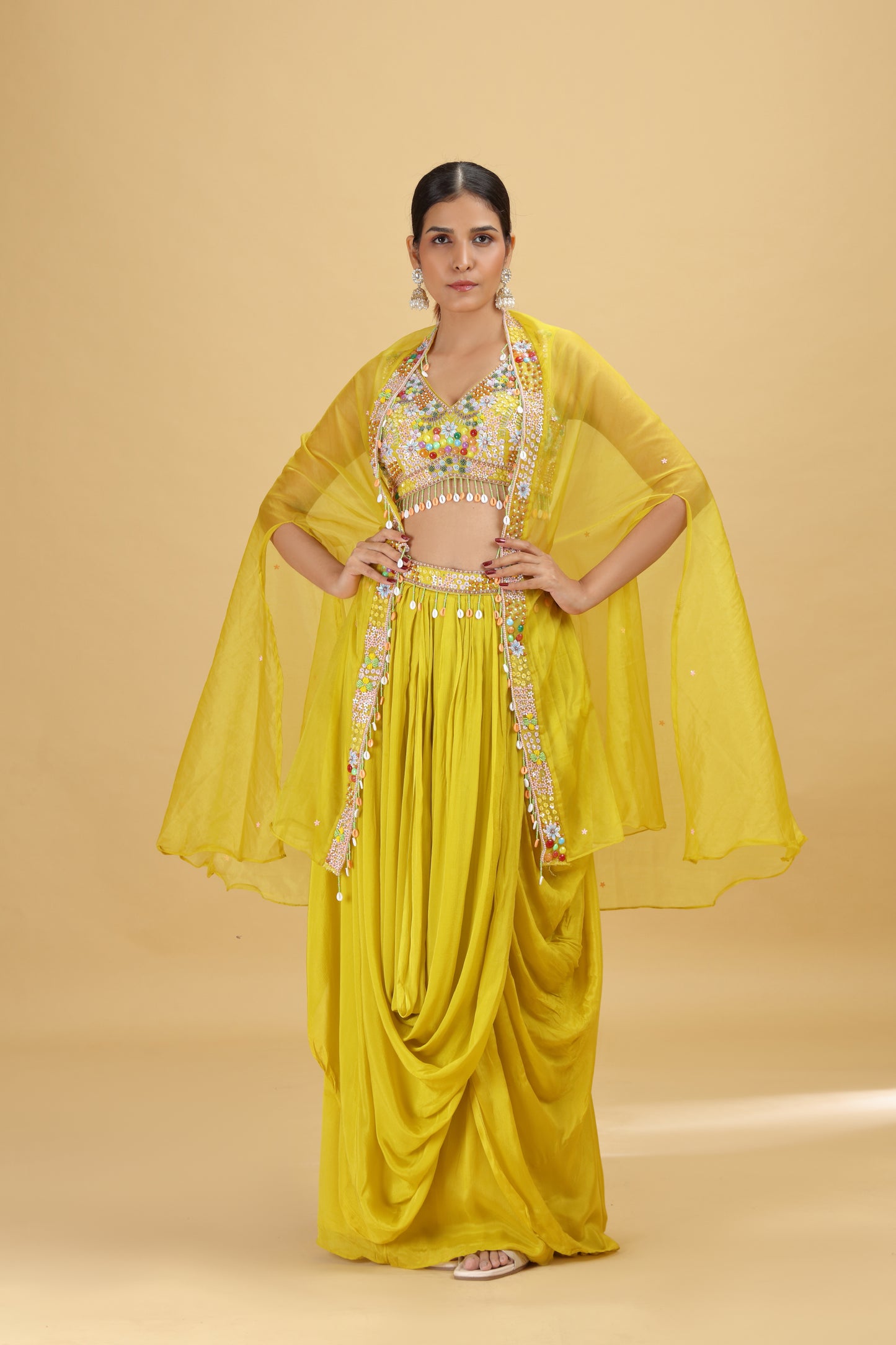 Woman wearing a lime yellow traditional outfit with a beige background