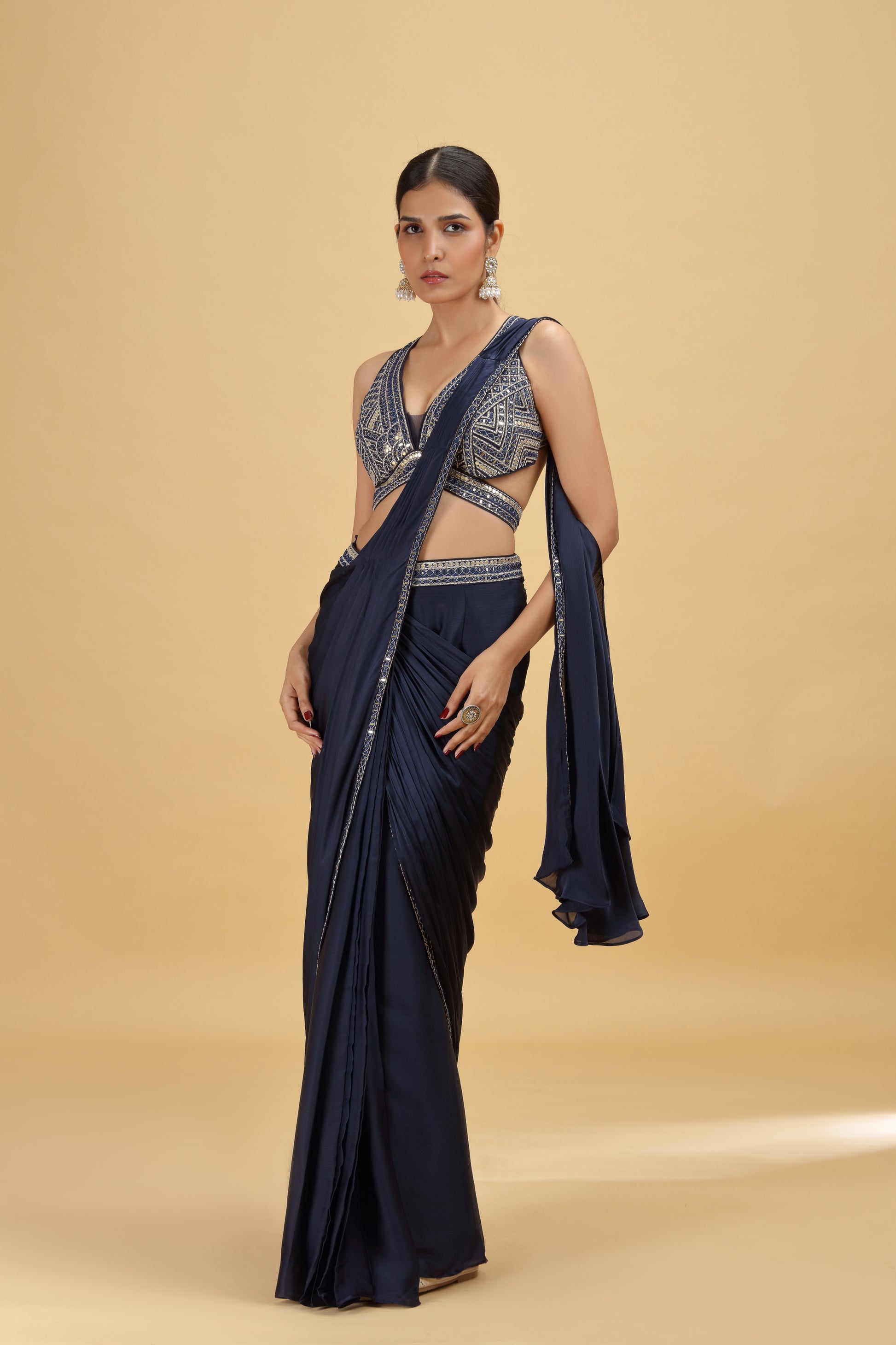 Woman in a navy blue color pure georgette saree with blouse piece