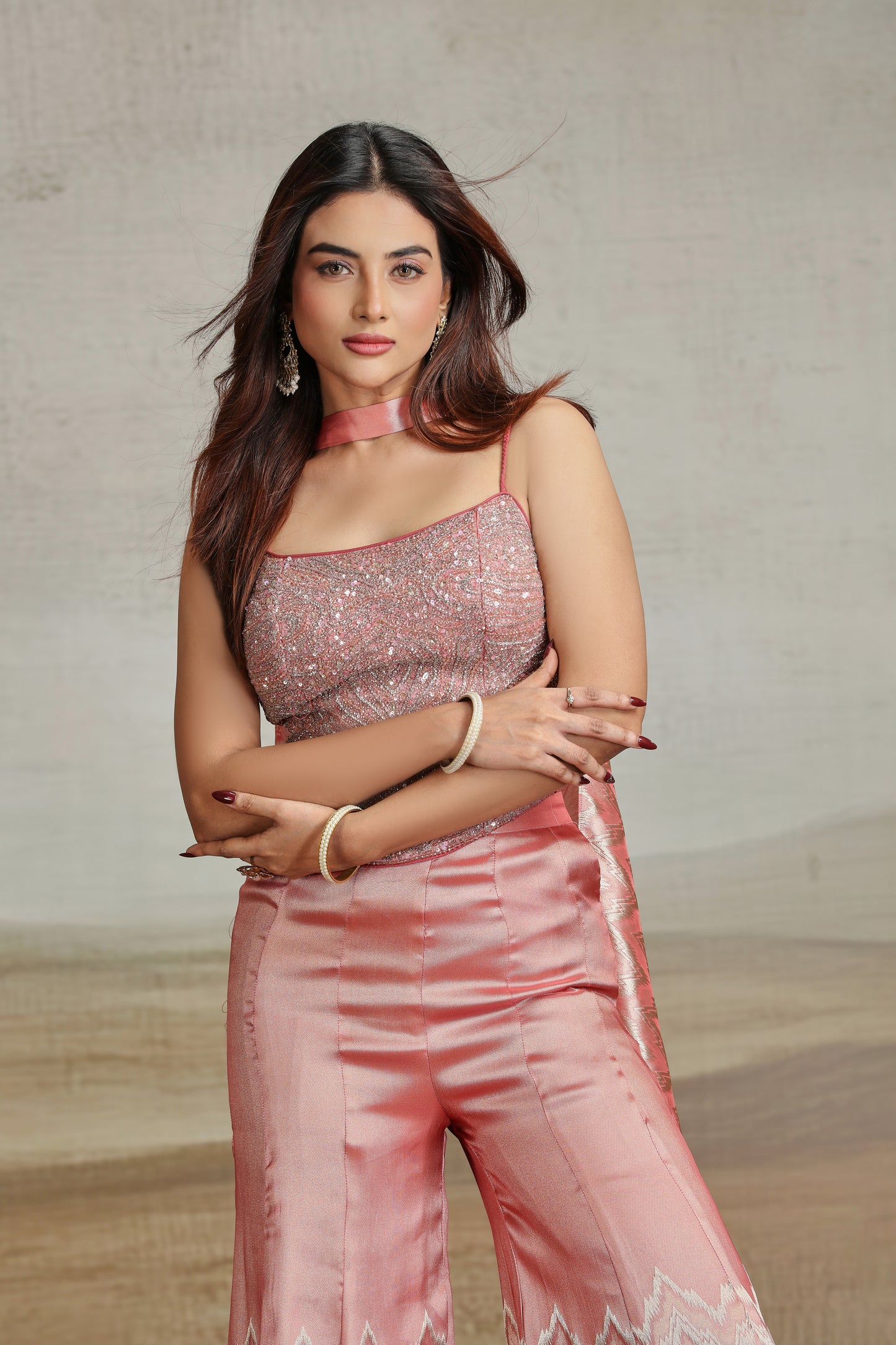 Woman in a peach salwar kameez with a neutral background